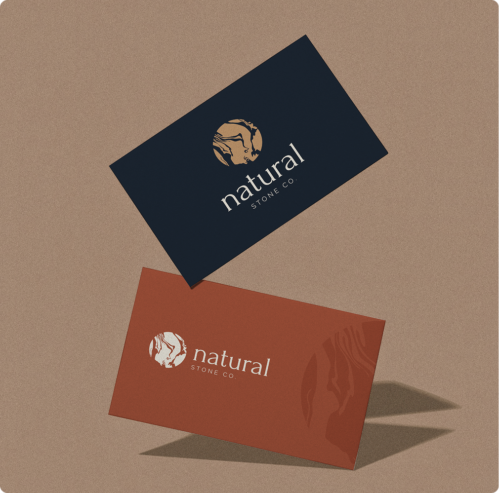 Natural Stone Co. business cards with logo designs on textured background.