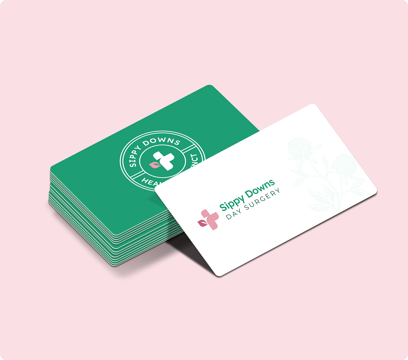 Stack of green and white business cards for Sippy Downs Day Surgery.