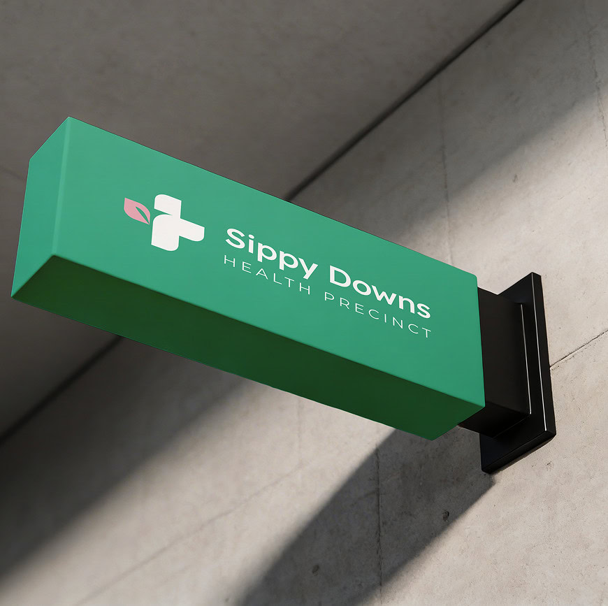 Sippy Downs Health Precinct sign on a modern building wall.